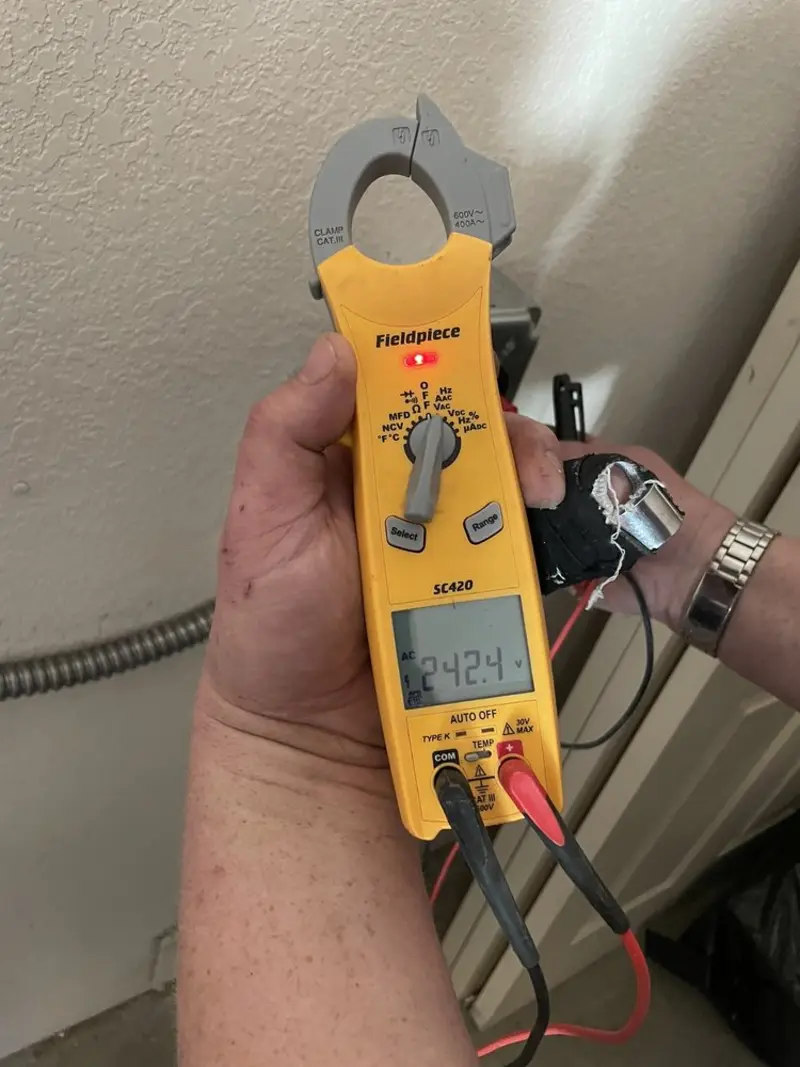 Voltage testing with clamp meter during Outlet Installation in Mount Morris